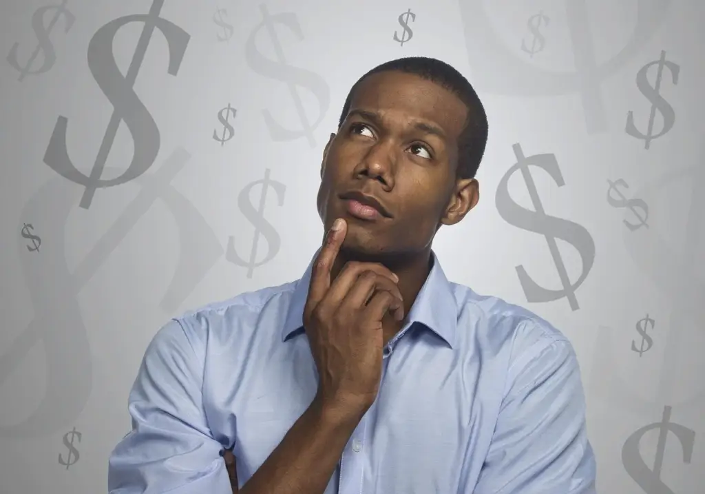 Person planning a budget with debt consolidation notes and a pen