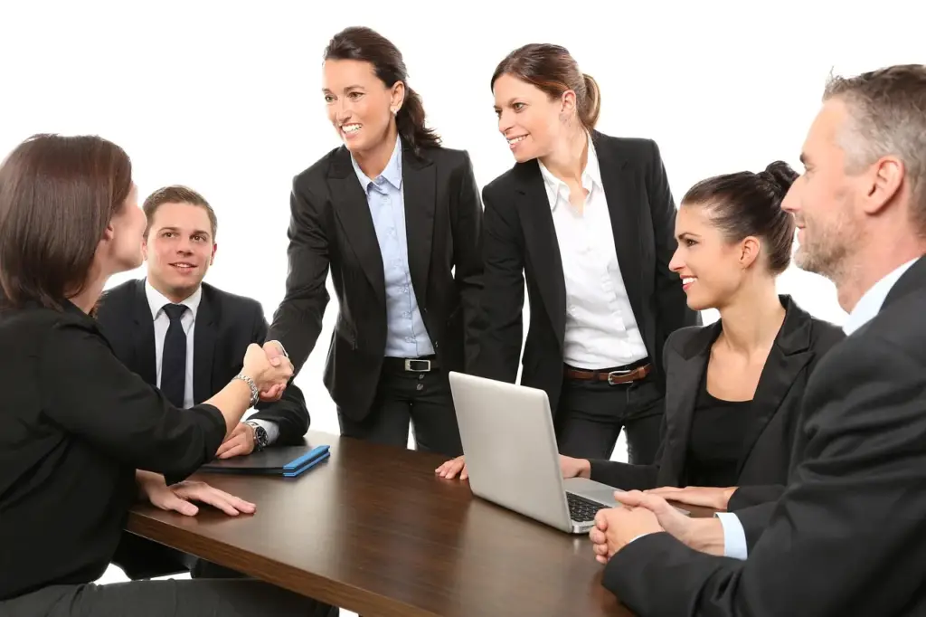 Business owner shaking hands with a lender while discussing a small business loan